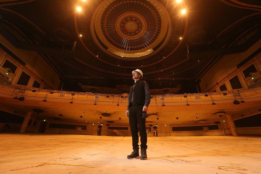 Architect Athos Zaghi stands on stage